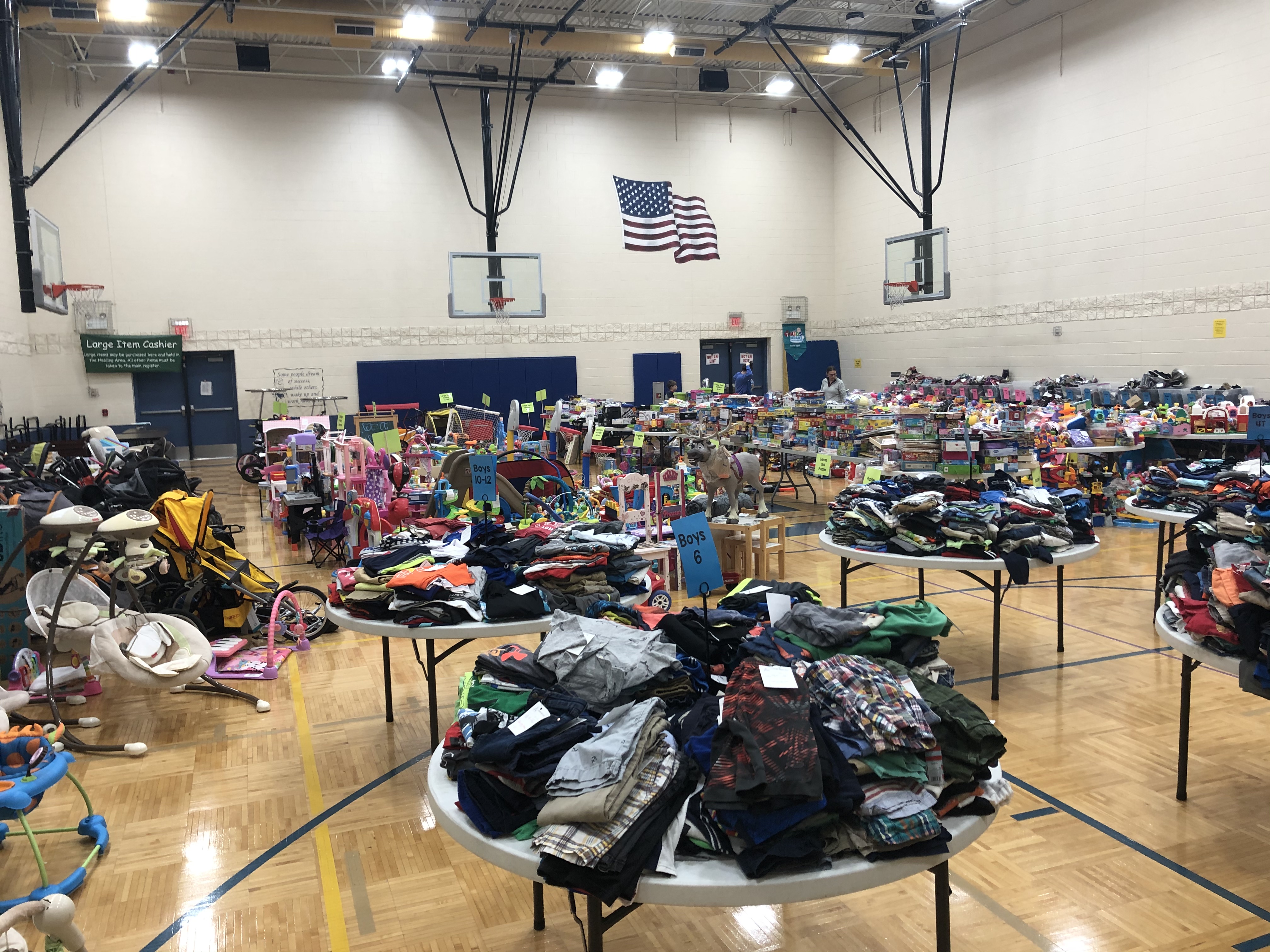 tables filled with consignment clothes, games and baby goods